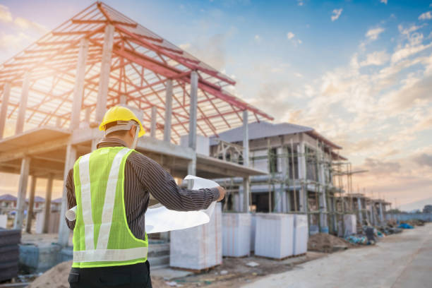 Professional engineer architect worker with protective helmet and blueprints paper at house building construction site background " design development process architecture"