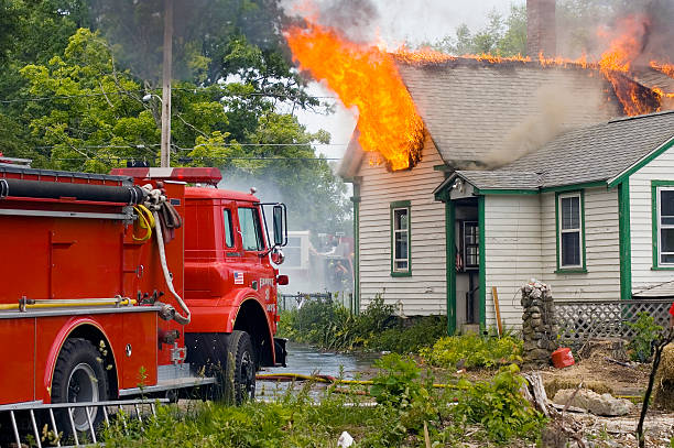 home and fire truck to control fire surrounded by greenery