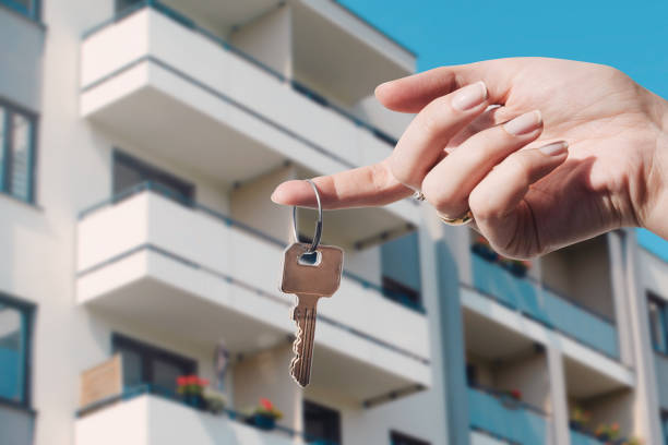 Property Investment Consultant Near Me in Los Angeles Real estate agent holding keys to new flat. Real estate, buy a home concept