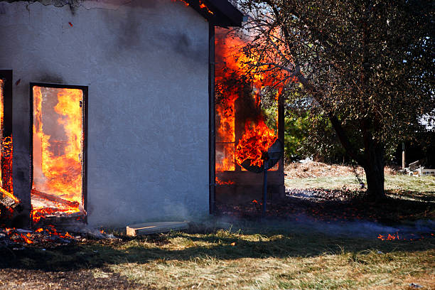 Training fire, house on fire. Made of stucco the interior burnt while the skin of the house flopped down. Vibrant flames shoot out of the remainder of the house. This shot is more about the add on back porch being burnt to a crisp. May be why the parabolic satellite dish never took off? Shot on a Canon 5D.