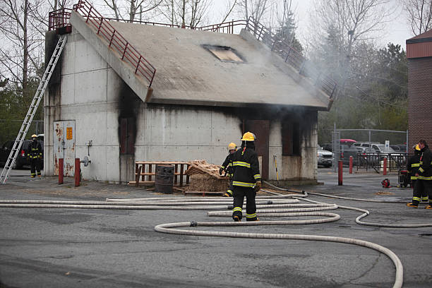 Fire training house with smoke and firefighters. What Are Defensible Space Fire Buffer Policies