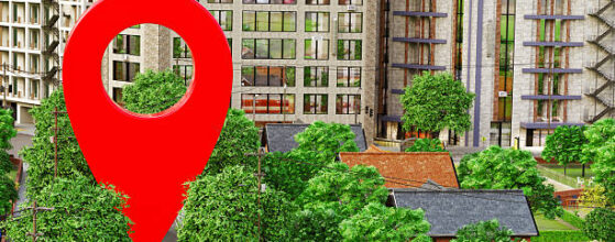 Digitally rendered illustration of a suburban neighborhood with houses, trees, and streets. The central focus is a large, red map location pin marker hovering over a street, symbolizing a geolocation or navigation point - commonly associated with GPS, maps, or location-based services. The setting is clean and modern, with a mix of single-family homes and urban buildings in the background, emphasizing the integration of digital tools with real-world environments. What is Community Plan Mean in Los Angeles: A Guide for Property Owners and Developers