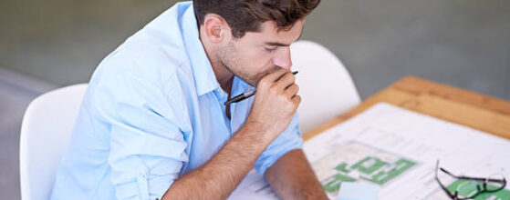 High-angle shot of a handsome architect pondering over his design, zoning analysts near me in los angeles