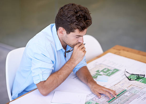 High-angle shot of a handsome architect pondering over his design, zoning analysts near me in los angeles