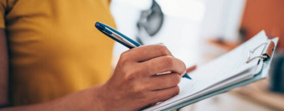 Cropped shot of an unrecognizable businesswoman making notes on a clipboard inside of the office.