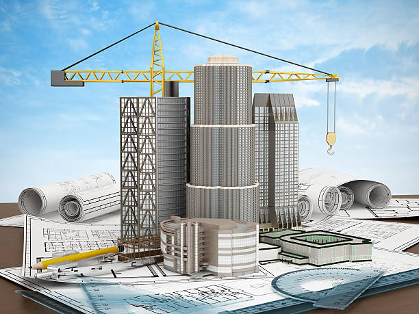 Buildings and construction crane standing on plans with ruler sets.Similar images: