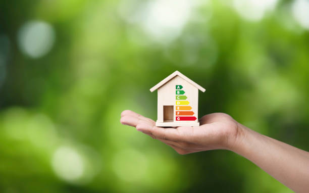 House energy efficiency, energy efficient rating class concept, eco home renovation save cost. Low-consumption ecological house. Hand holding Green Building for Sustainable Development Concept , Common CEQA Exemptions in Los Angeles: A Developer’s Guide to Faster Project Approvals