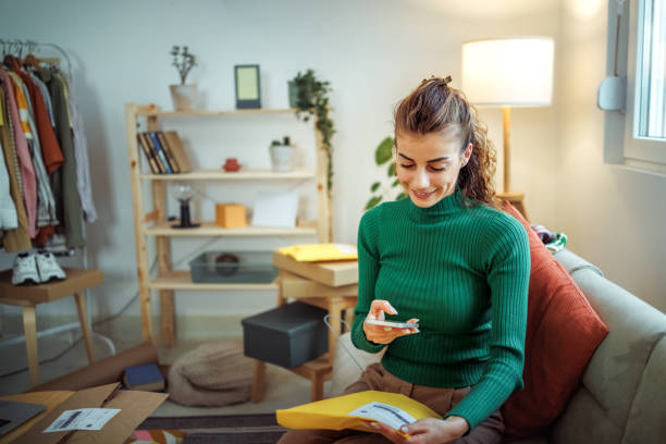 Adaptive Re‑Use Ordinance 2.0: Turning Offices into Housing in the article, Young casually clothed woman taking photo of her envelope that is ready for delivery at her home based clothing store