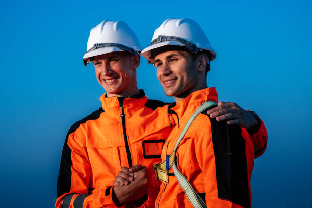 Welcome hand shake, Two engineers team work at wind turbines