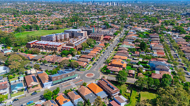Aerial Drone view of Sydney Urban Sprawl and Suburban housing Suburb of Ashbury and Croydon with roof tops, the streets and the parks NSW Australia