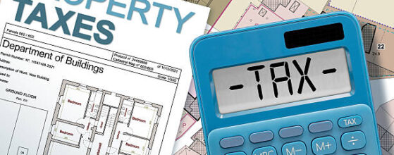 PROPERTY AND REAL ESTATE TAXES CONCEPT WITH CALCULATOR, imaginary cadastral map and general urban plan