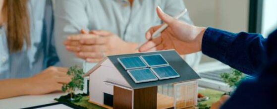 Closeup of young Asian couple in detailed consultation with real estate agent, who is highlighting advantages of home with solar panels. Consulting on Eco-Friendly Home with Real Estate Agent Concept. illustrating LADBS Express Permit