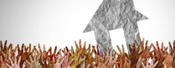 Selling A Home as a group of diverse home buyers reaching for real estate success in a seller market as a symbol for buying a house and affordability challenges to residential ownership.