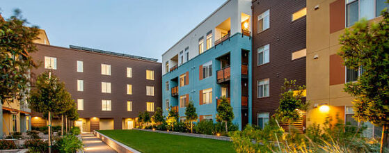 Modern apartment building at dusk.