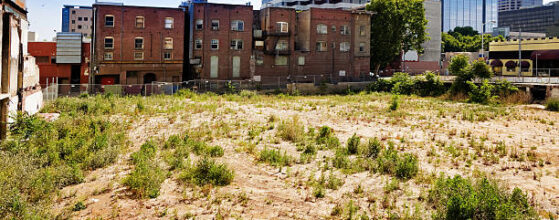 Turning Vacant Lots into Homes | Run down brick buildings and an empty lot in downtown Sacramento, California.
