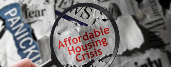 Affordable Housing Crisis newspaper headline and magnifying glass