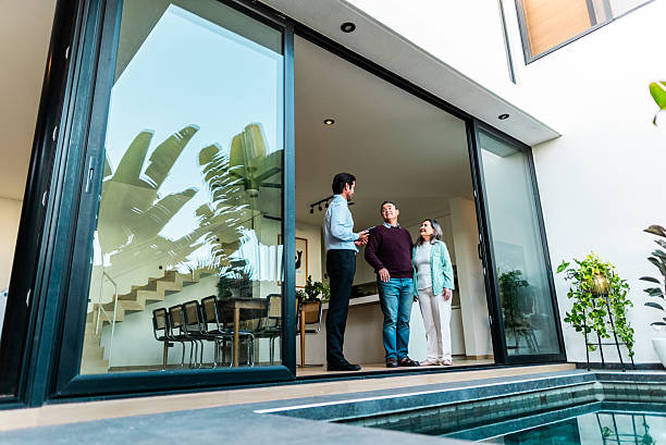 Real estate agent showing house to senior couple customers