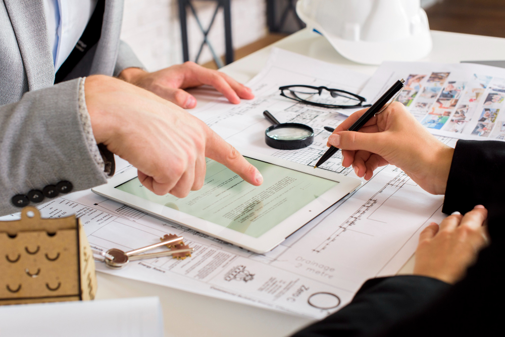 Businessmen analyzing a business plan on a tablet